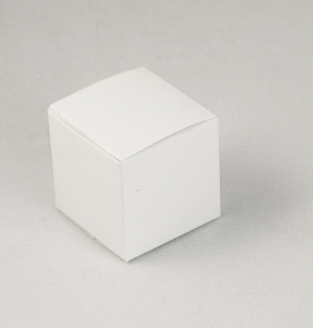 A pack of 10 white 5cm square cube gift boxes, ideal for weddings and events, neatly folded and ready for assembly.