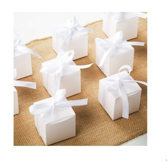 A pack of 10 white 5cm square cube gift boxes, ideal for weddings and events, neatly folded and ready for assembly.