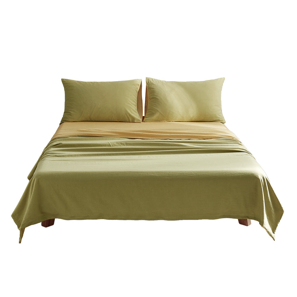 100% washed cotton bed sheet set in yellow, featuring a flat sheet, fitted sheet, and two pillow cases, showcasing a soft and breathable texture.