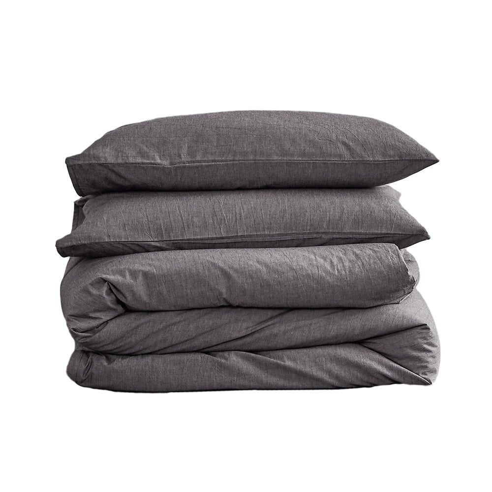 100% washed cotton quilt set in double black, featuring a soft and plush texture, perfect for a cozy bedroom setting.