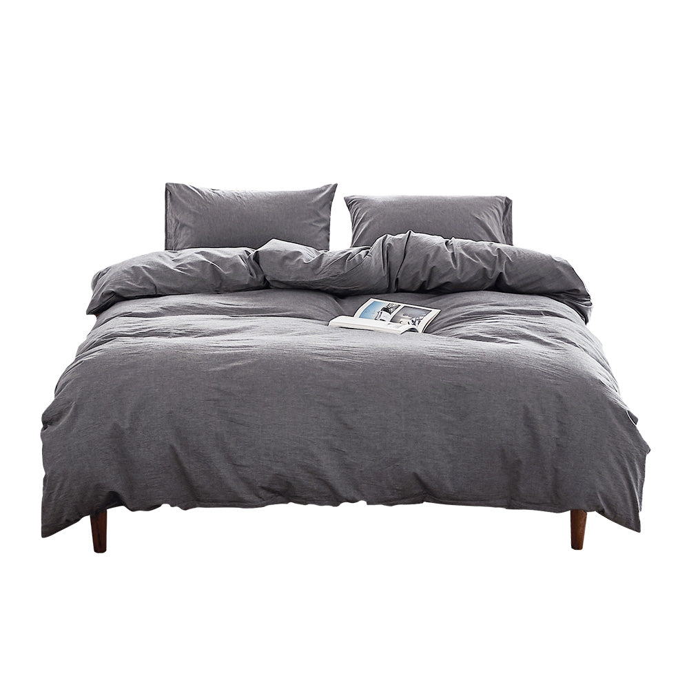 100% washed cotton quilt set in double black, featuring a soft and plush texture, perfect for a cozy bedroom setting.