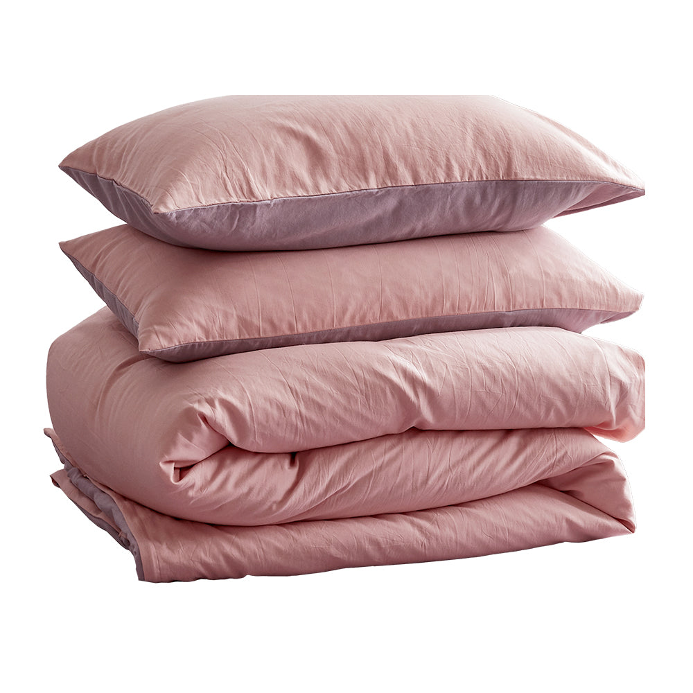 100% washed cotton quilt set in pink and purple, featuring a textured design and lightweight fabric, perfect for cozy bedding.