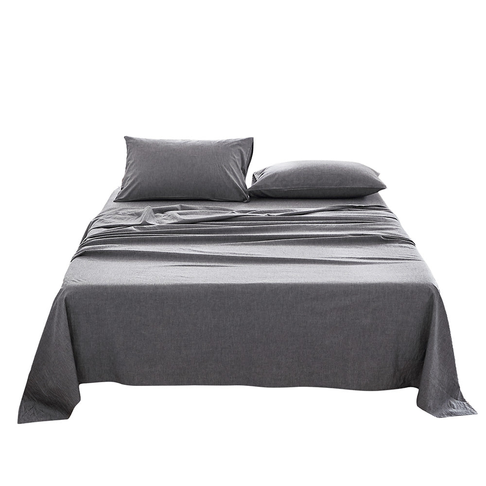 100% washed cotton sheet set in black, featuring a flat sheet, fitted sheet, and two pillowcases, showcasing a soft and breathable texture.