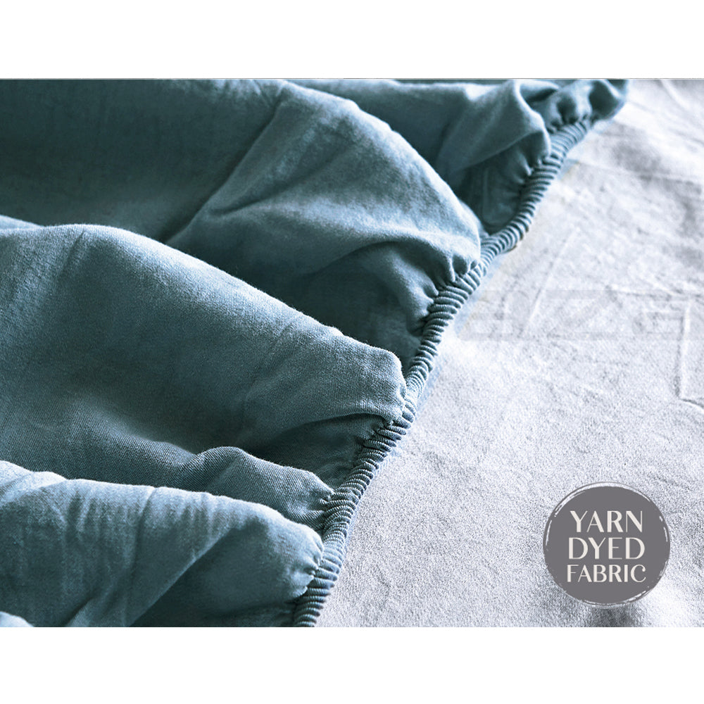 100% washed cotton sheet set in blue, featuring a flat sheet, fitted sheet, and two pillowcases, showcasing a soft and breathable texture.