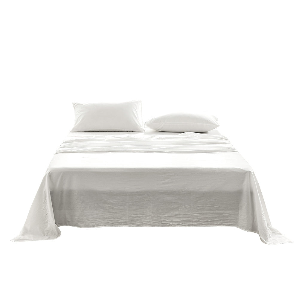 A luxurious 100% washed cotton sheet set in white, featuring a soft texture and lightweight design, perfect for all year round comfort.