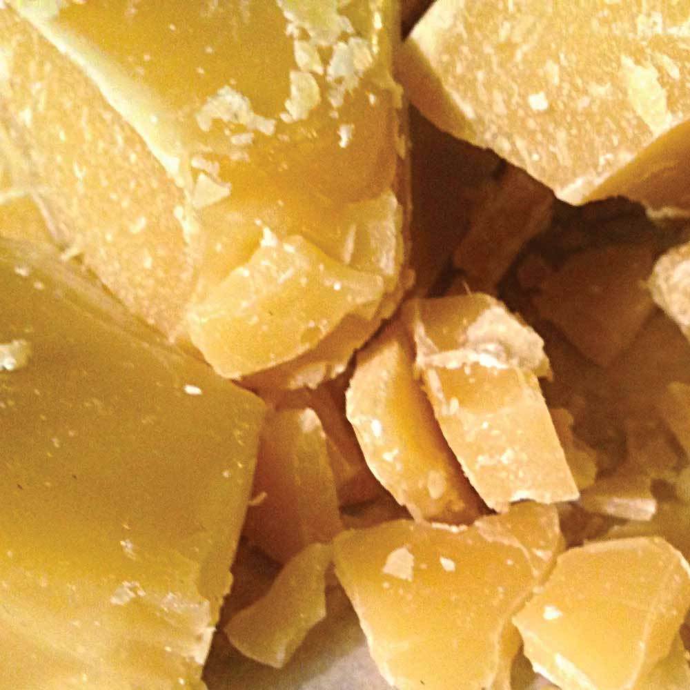 100g blocks of pure Australian beeswax, unrefined and natural, showcasing a rustic texture and yellow hue.