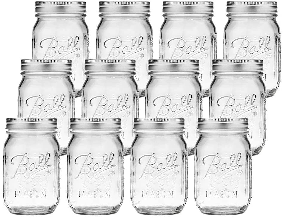 Set of 12 empty 480ml glass Mason jars with lids, ideal for spices and preserves, displayed on a wooden kitchen countertop.