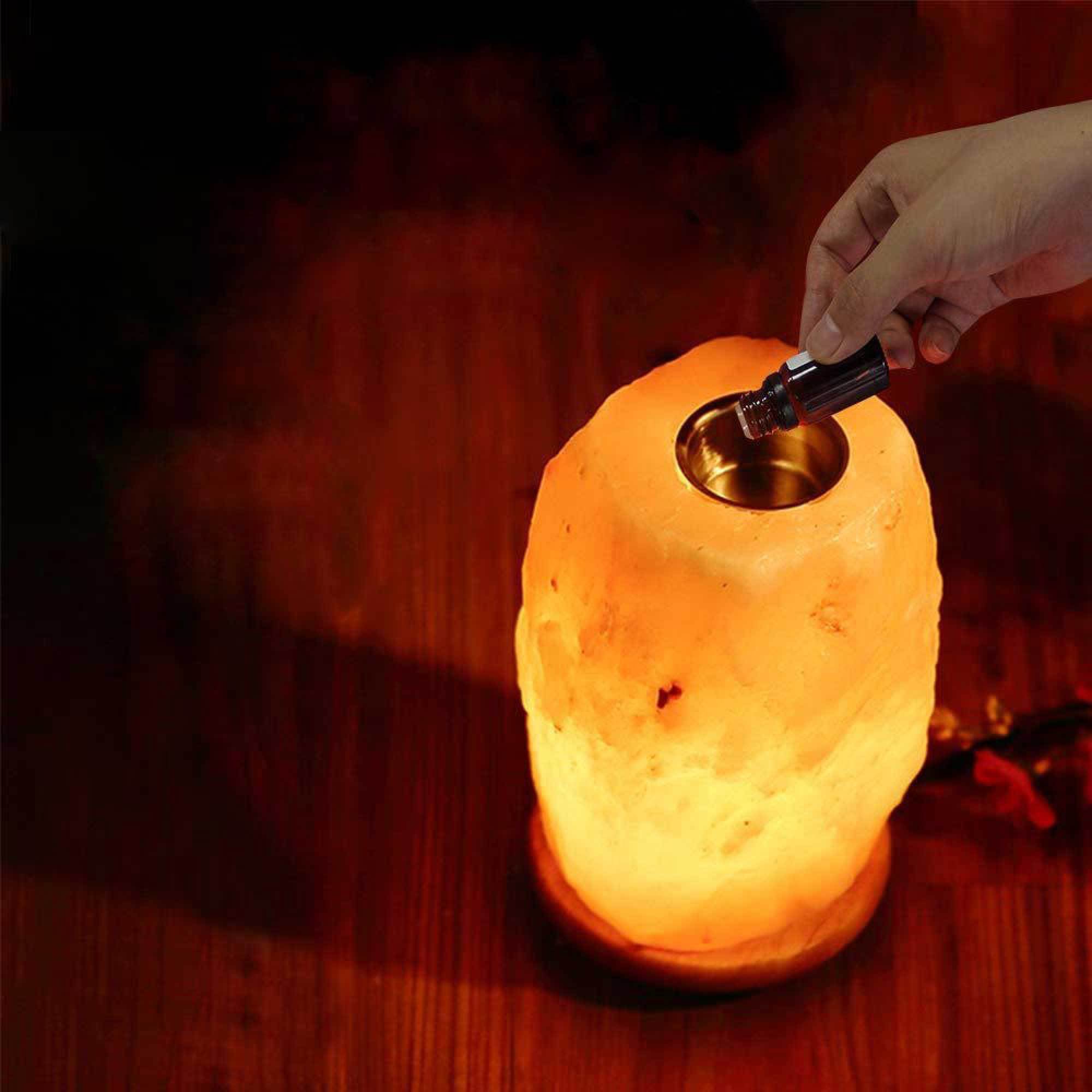 A beautifully handcrafted Himalayan pink salt diffuser lamp with a warm glow, showcasing its natural rock texture and wooden base.