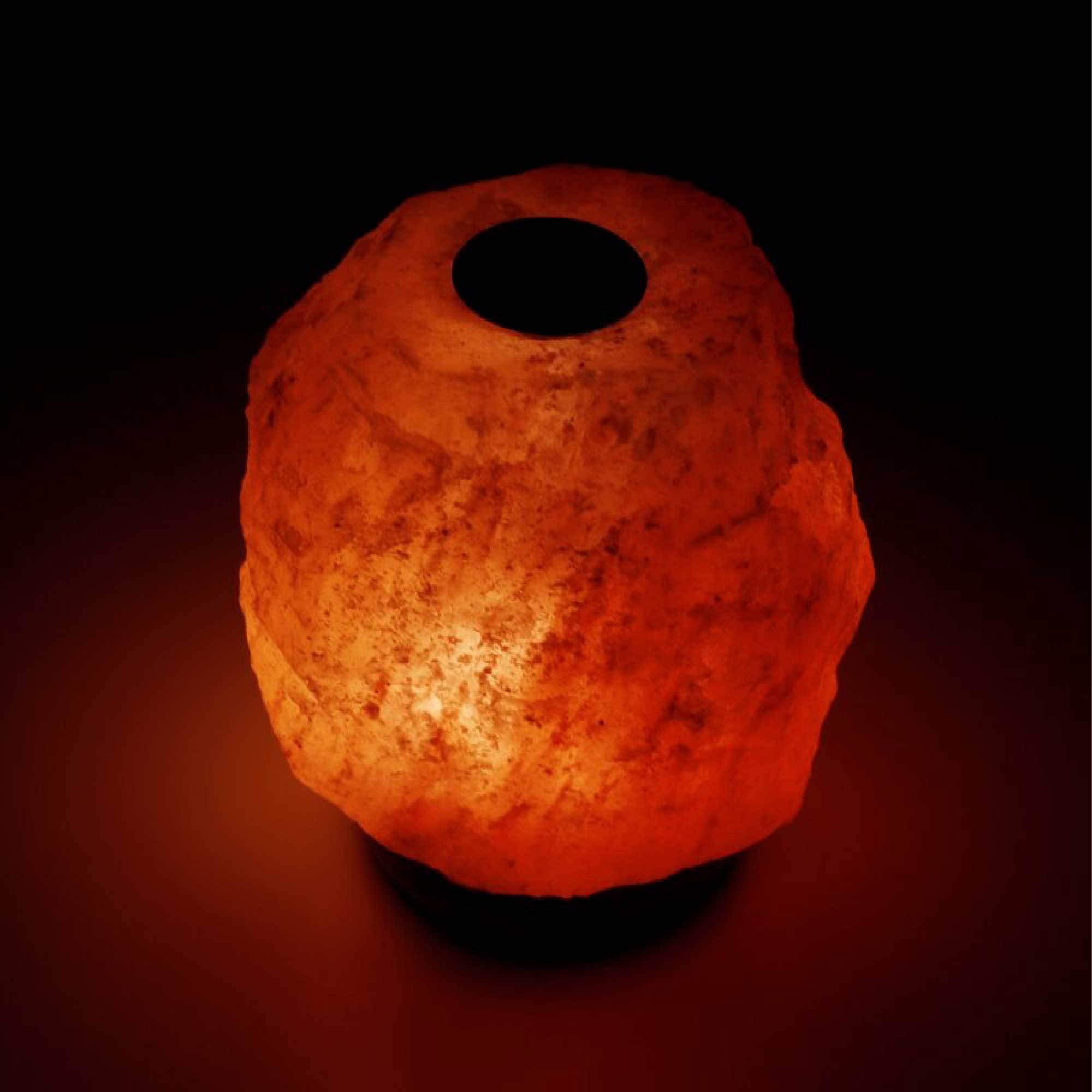 A beautifully handcrafted Himalayan pink salt diffuser lamp with a warm glow, showcasing its natural rock texture and wooden base.