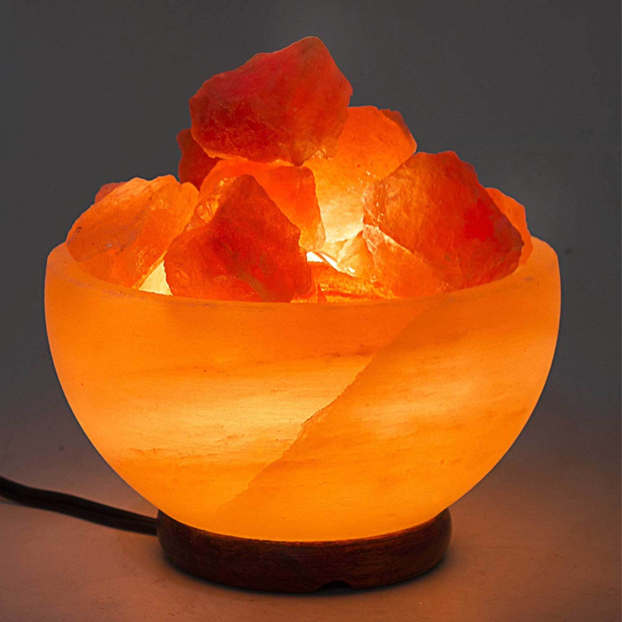 A beautifully carved Fire Bowl Himalayan Pink Salt Lamp, showcasing its natural pink hues and unique rock formations, illuminated with a warm glow.