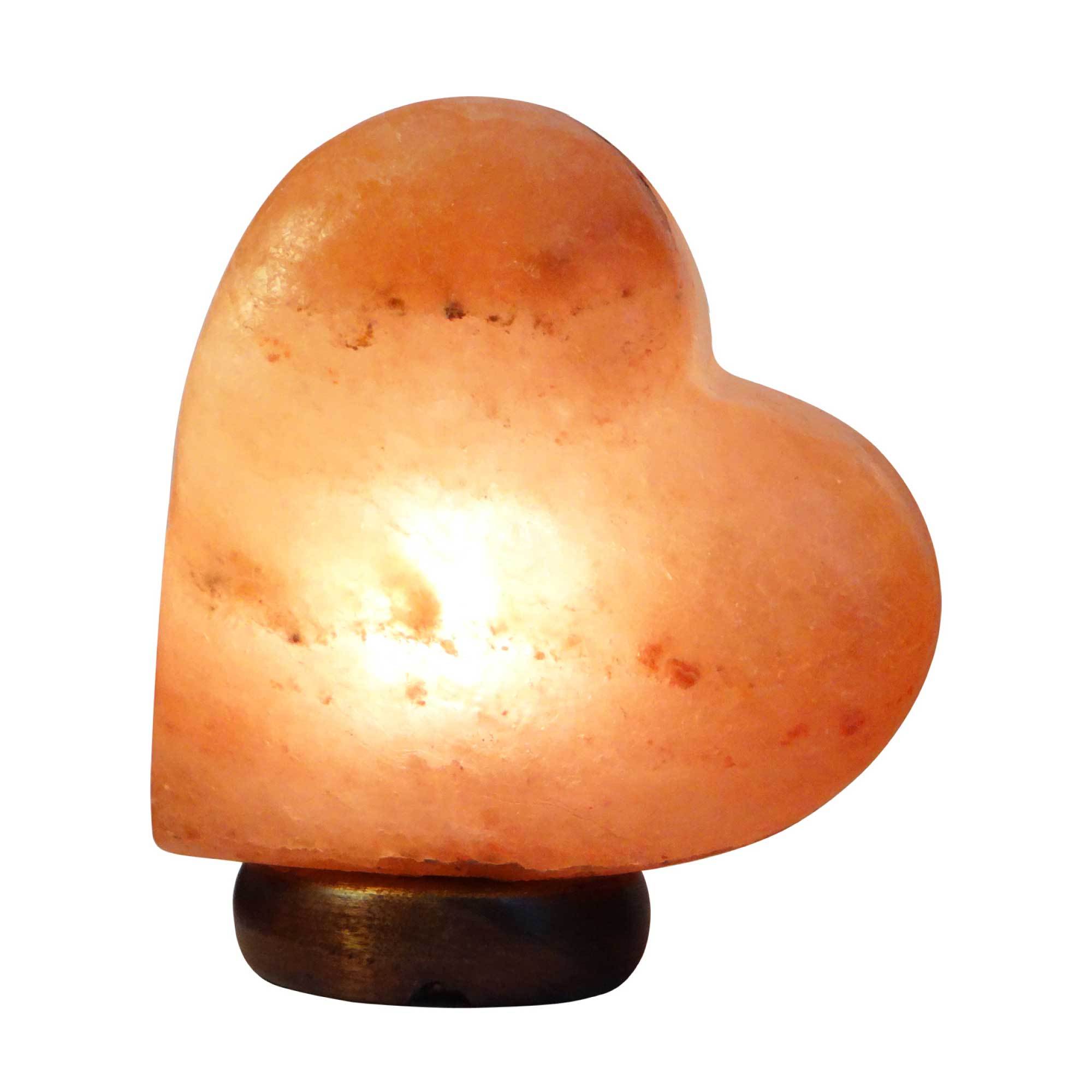 A beautifully handcrafted heart-shaped Himalayan pink salt lamp with a warm glow, resting on a wooden base, showcasing natural variations in color.