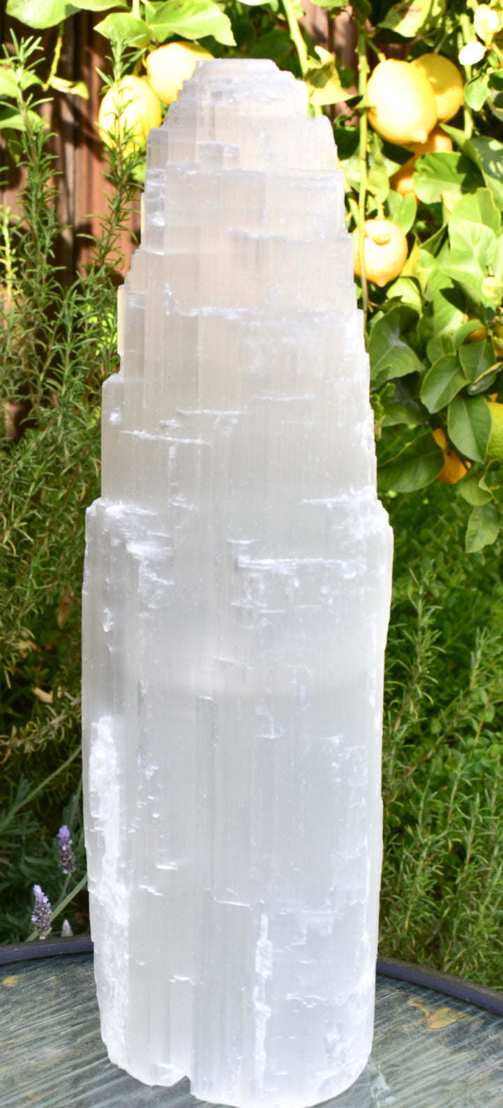 A beautiful 14-inch selenite tower with a glowing LED tealight base, showcasing its elegant design and natural crystal properties.