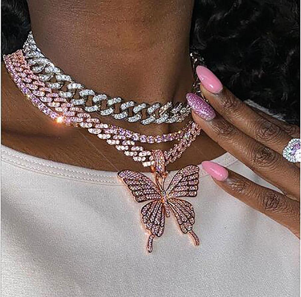 14K Iced Out Butterfly Pendant Necklace featuring a pink Cuban chain and sparkling cubic zirconia stones.