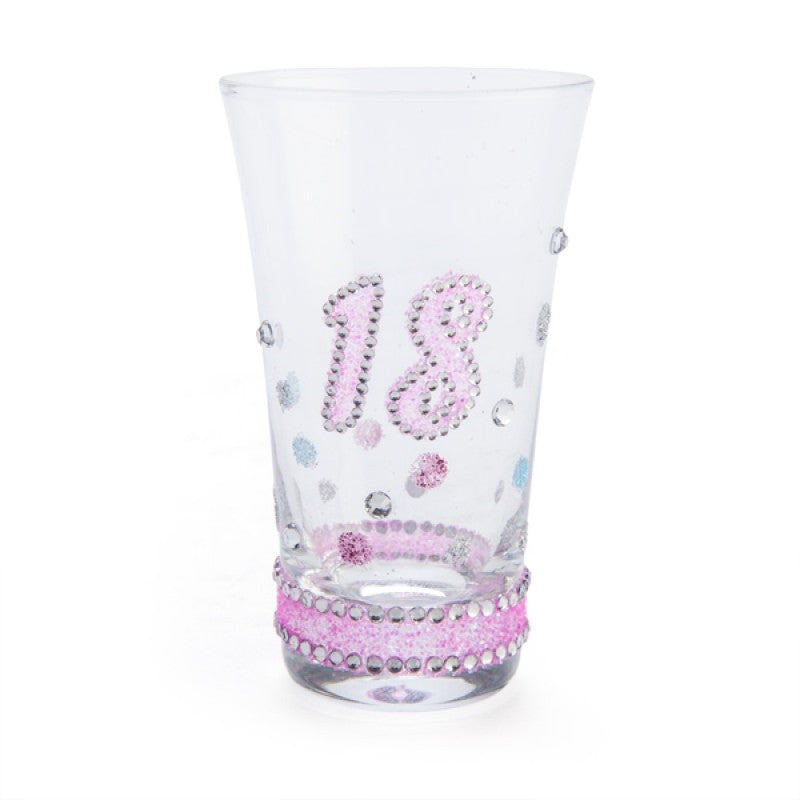 Clear shot glass with a silver glittered stem, pink base, and sparkling '18' in pink glitter adorned with colorful pastel bubbles.