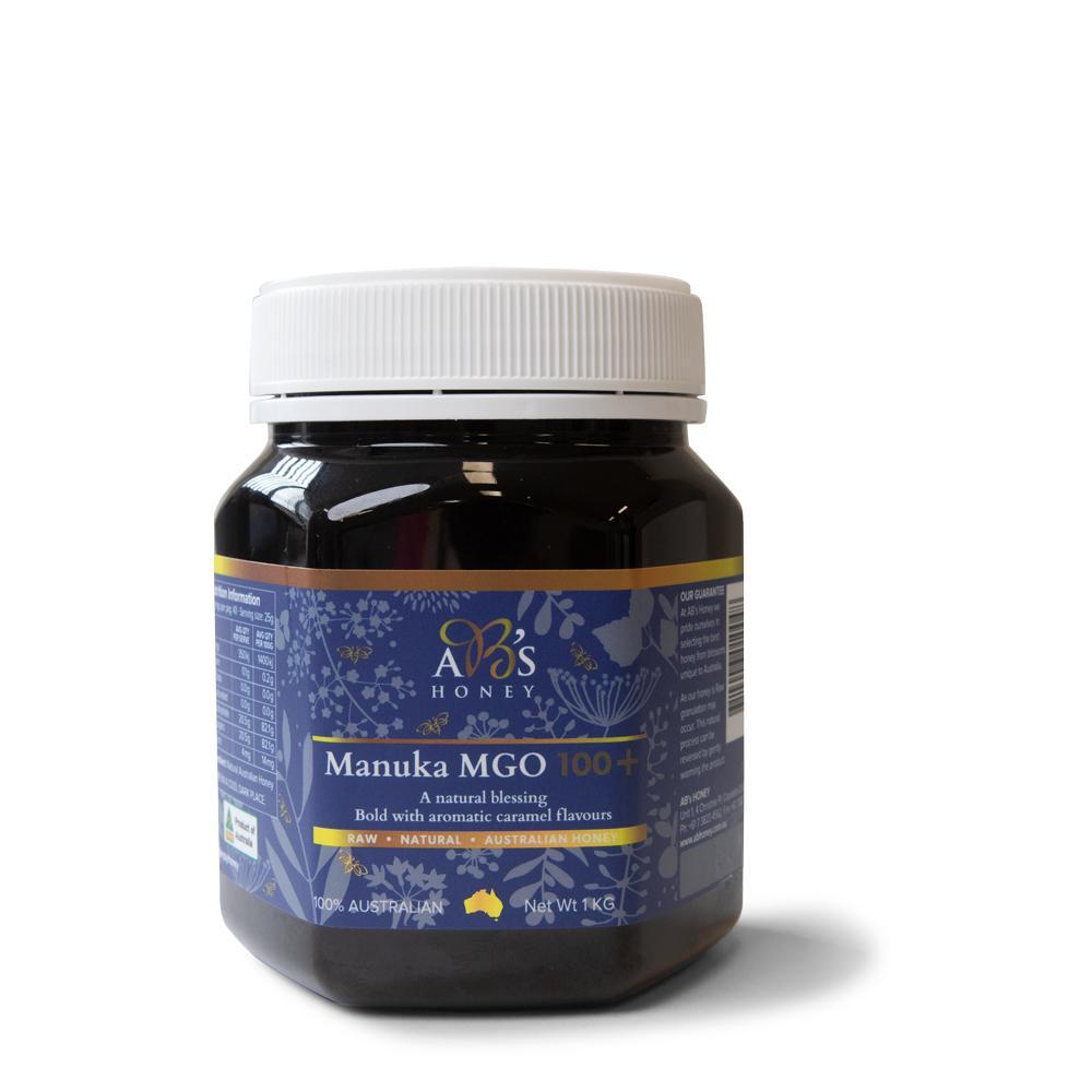 1Kg jar of AB's MGO 100+ Australian Manuka Honey, showcasing its rich dark color and label.