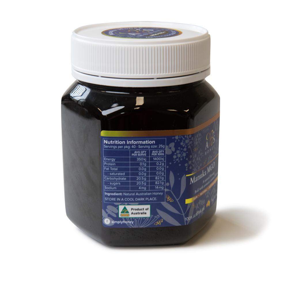 1Kg jar of AB's MGO 100+ Australian Manuka Honey, showcasing its rich dark color and label.