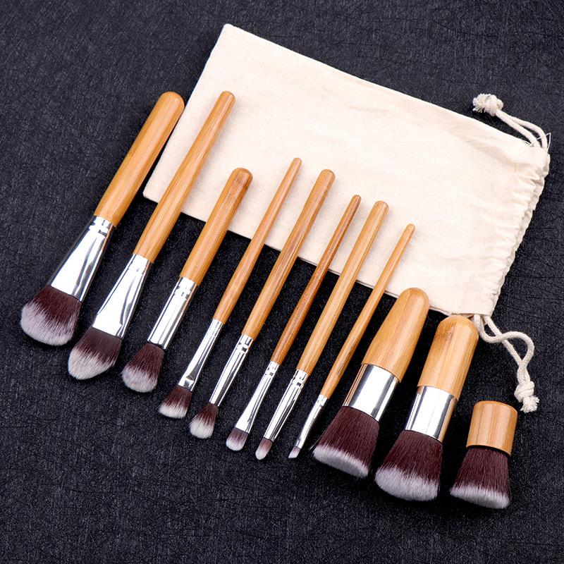 A set of 11 women's fashion makeup brushes with bamboo handles and synthetic hair bristles, ideal for foundation and eyebrow application.