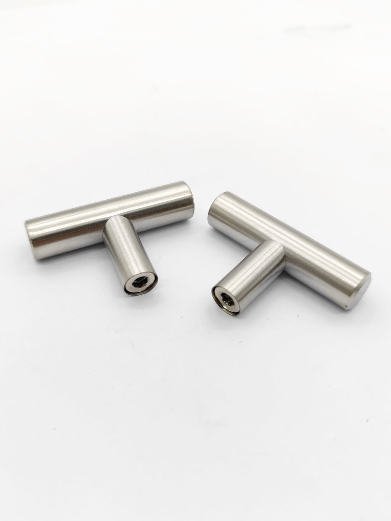 Two sleek RST handles in silver and black, perfect for modern furniture.