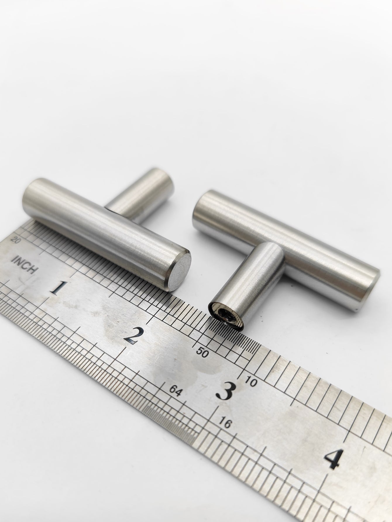 Two sleek RST handles in silver and black, perfect for modern furniture.