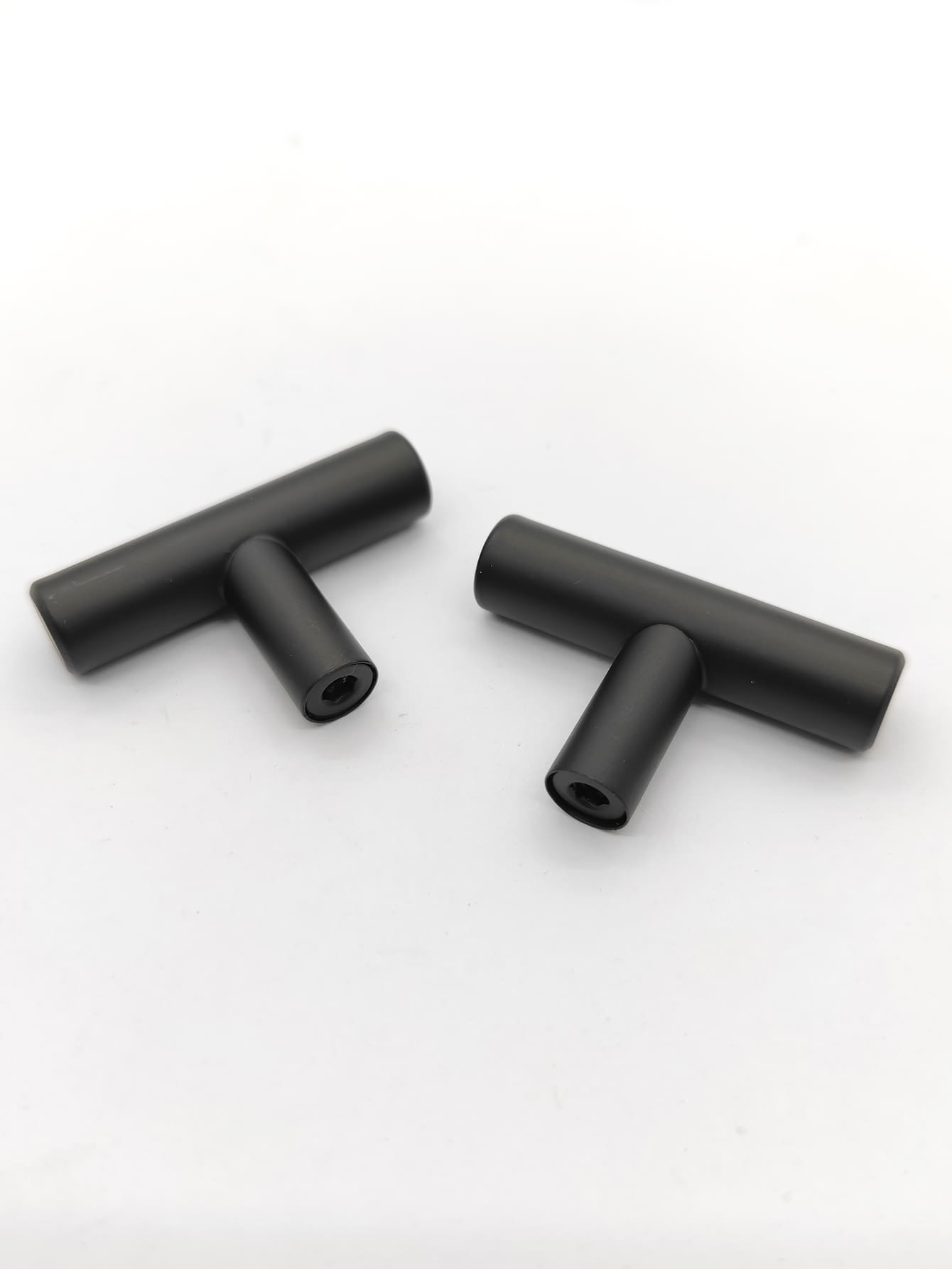 Two sleek RST handles in silver and black, perfect for modern furniture.