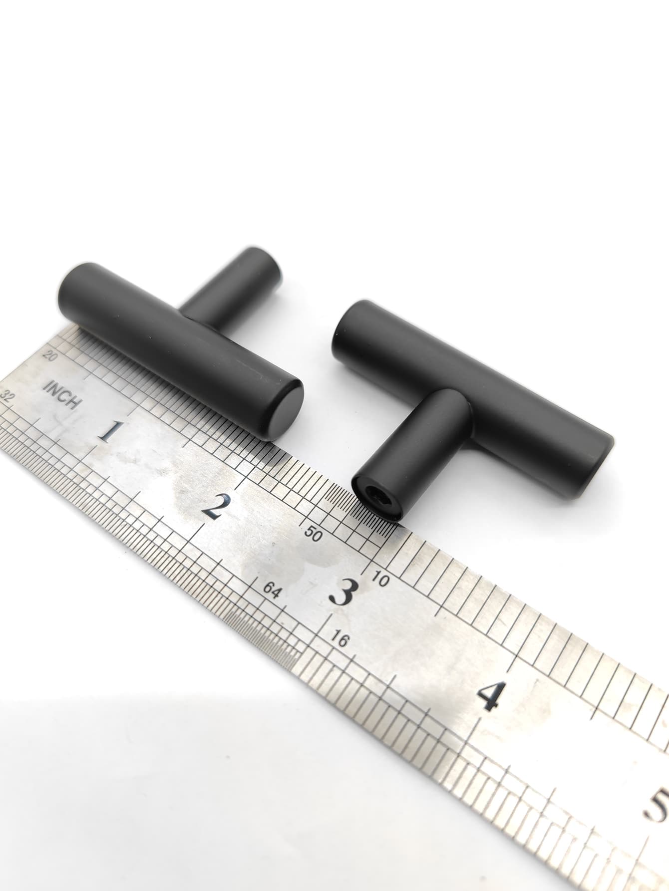 Two sleek RST handles in silver and black, perfect for modern furniture.