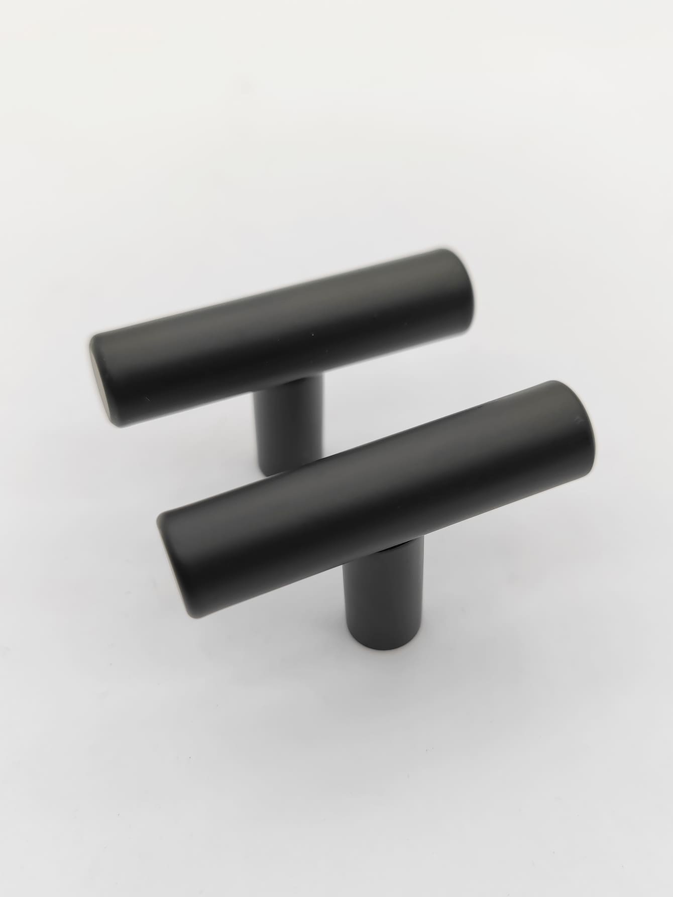 Two sleek RST handles in silver and black, perfect for modern furniture.