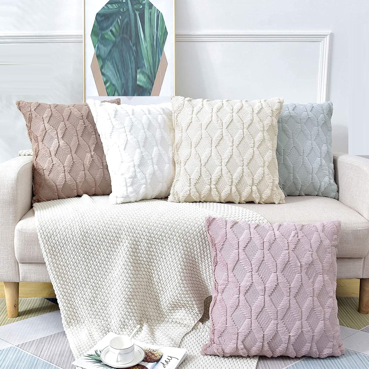 Two decorative boho throw pillow covers in white, featuring soft faux fur with a diamond design, perfect for home decor.