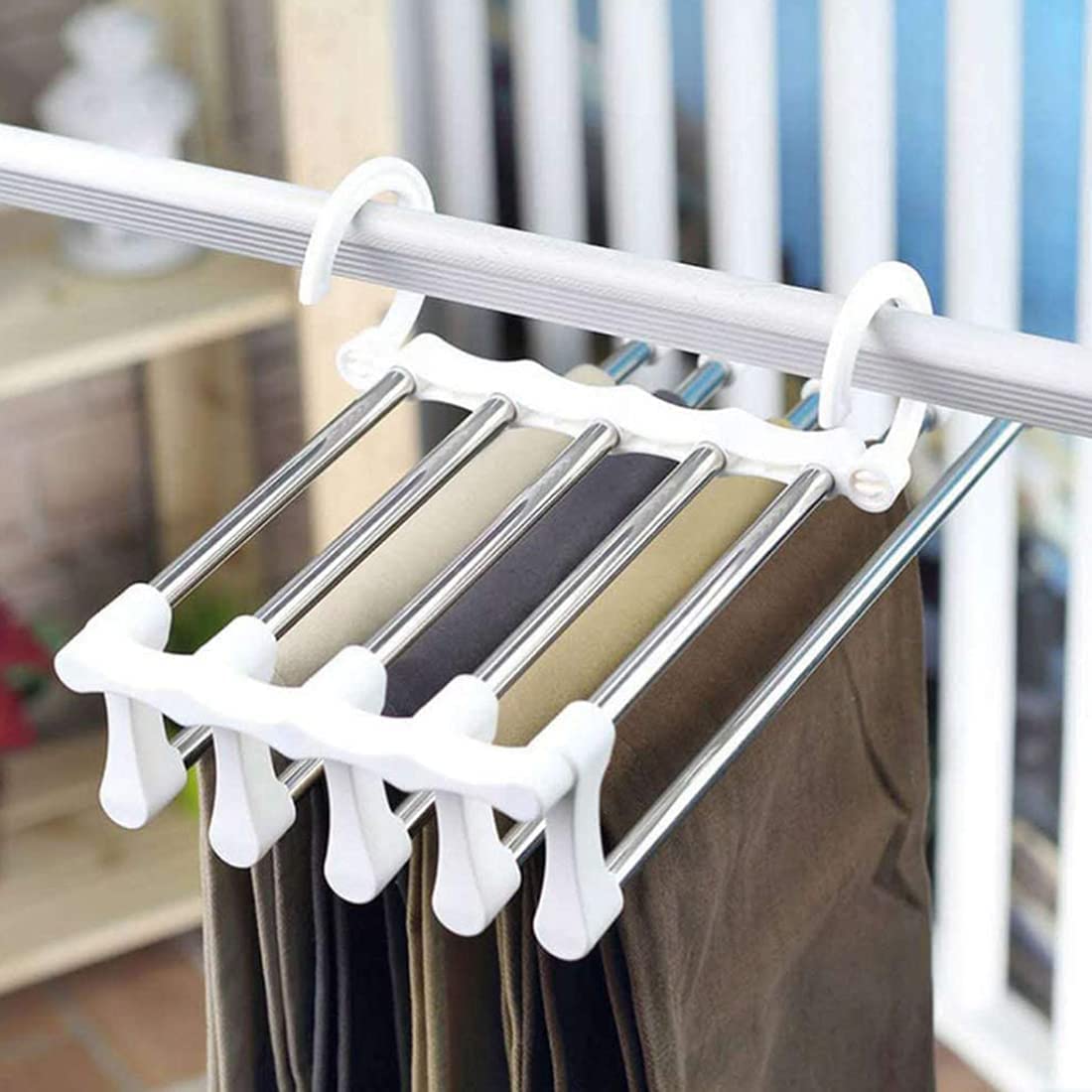 Two stainless steel adjustable pants hangers designed for space-saving storage, holding multiple trousers and accessories neatly organized.