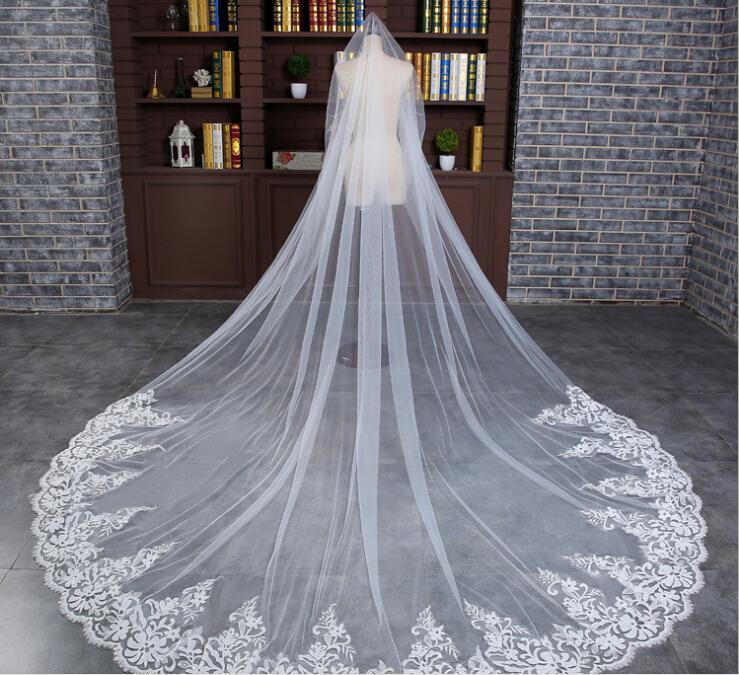 2017 Luxury Royal Cathedral Train Bridal Veil with lace applique edge, 3 meters long, elegantly displayed.