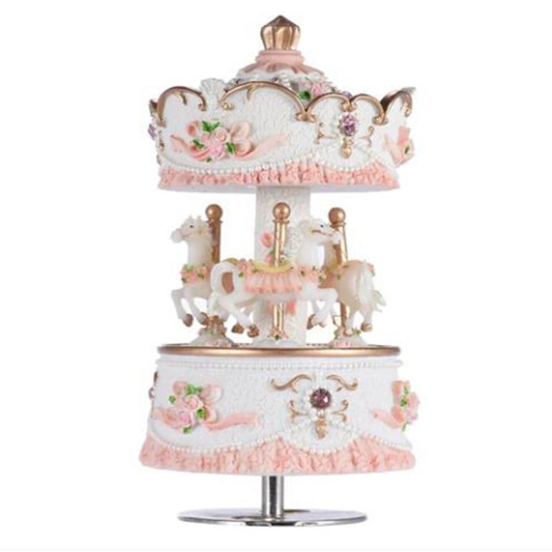 2018 Luxury Windup Carousel Music Box with three rotating horses and intricate carvings, in pink color.