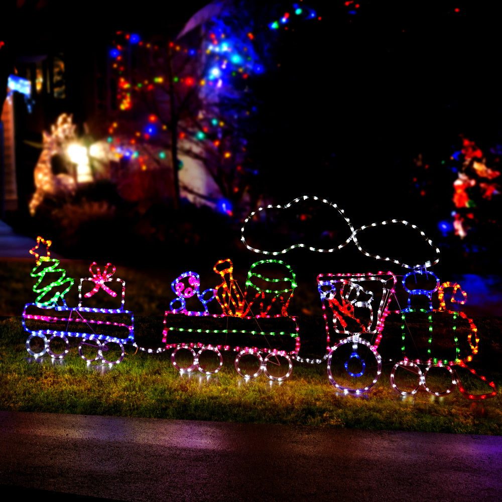 A beautifully illuminated 2.1M LED Rope Train with colorful lights, showcasing a festive Christmas decoration set.