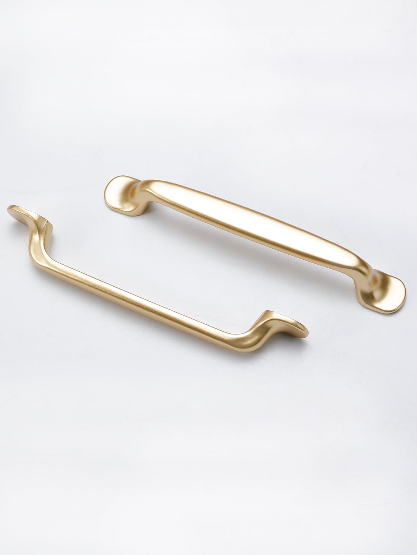 Two golden minimalist handles made of aluminum alloy, showcasing a sleek and modern design suitable for various furniture.