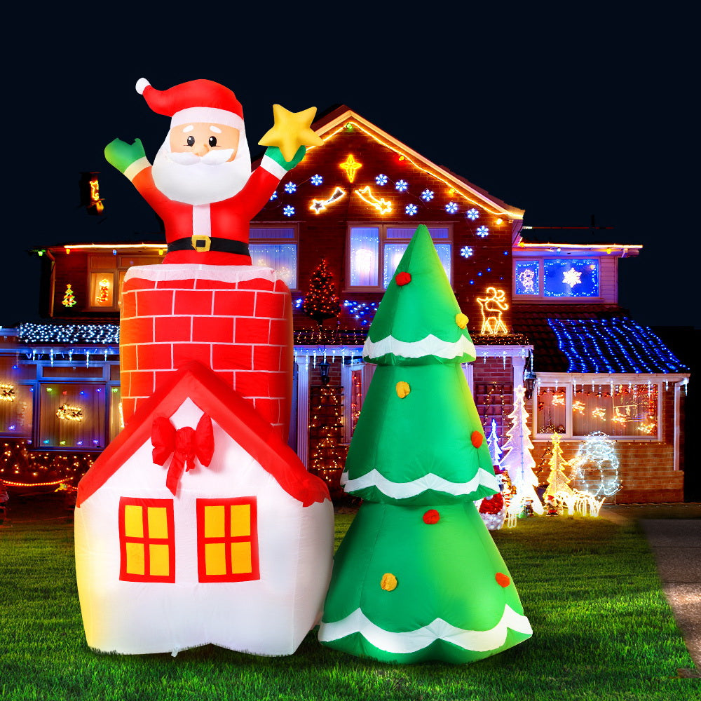 A vibrant 2.2M inflatable Santa in a chimney, surrounded by a colorful tree, perfect for Christmas decorations.