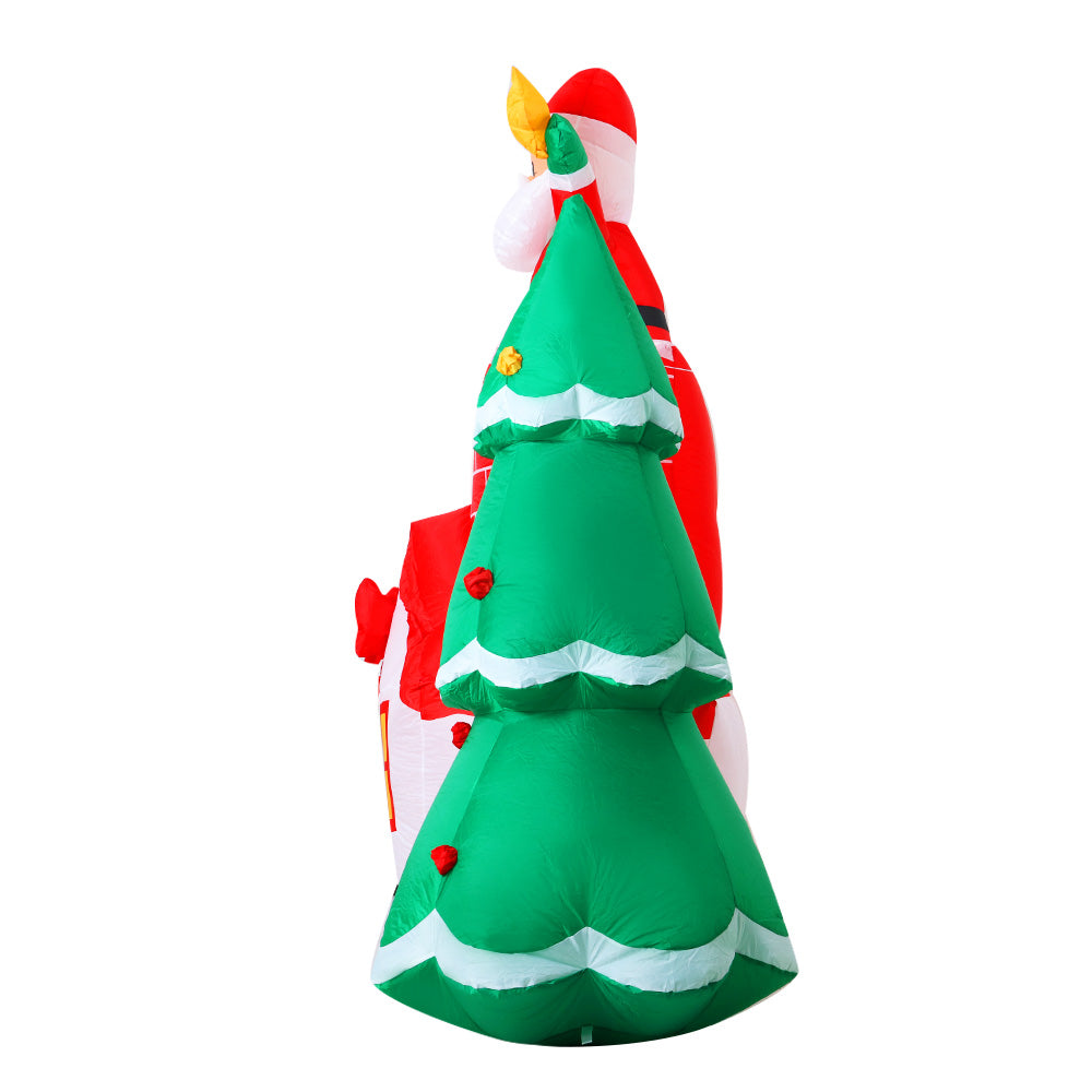 A vibrant 2.2M inflatable Santa in a chimney, surrounded by a colorful tree, perfect for Christmas decorations.