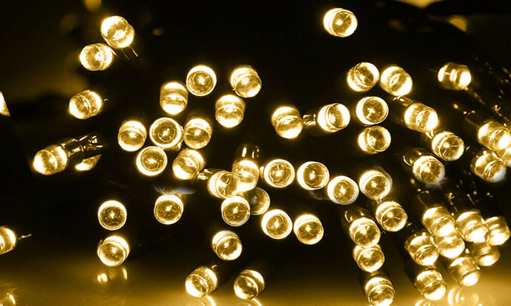 30M 300LED solar powered fairy lights with warm white glow, perfect for outdoor decoration in gardens and patios.