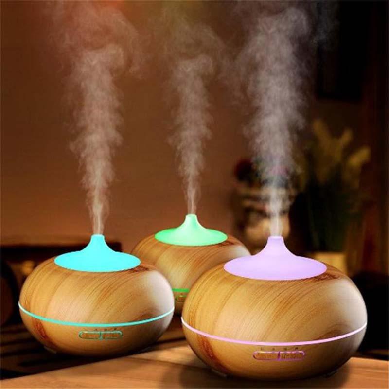 300ml Aroma Diffuser with wood grain finish, emitting cool mist for aromatherapy.