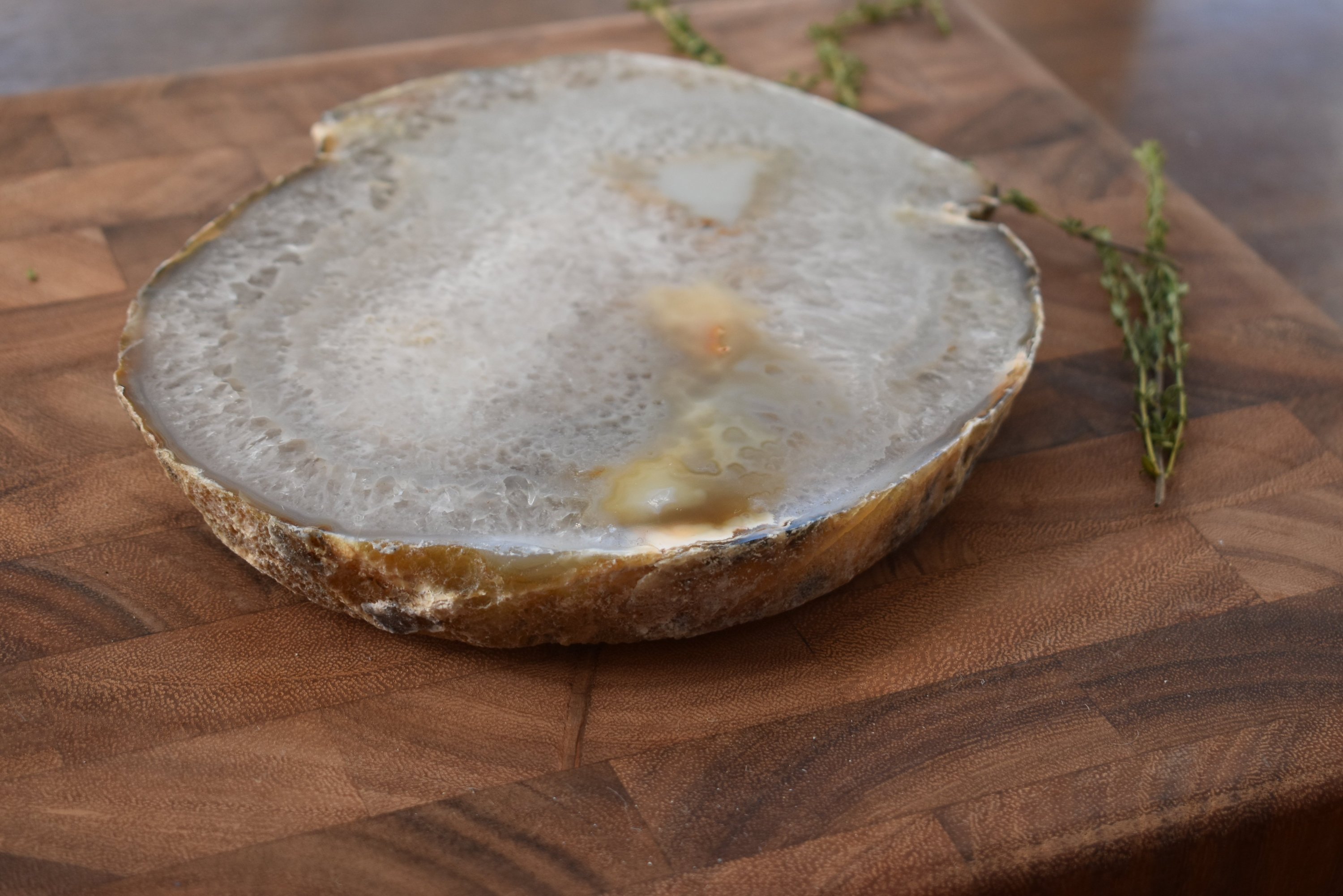 A beautiful 3/4-inch thick agate platter with natural trim, showcasing unique colors and patterns, perfect for serving food or as a decorative piece.