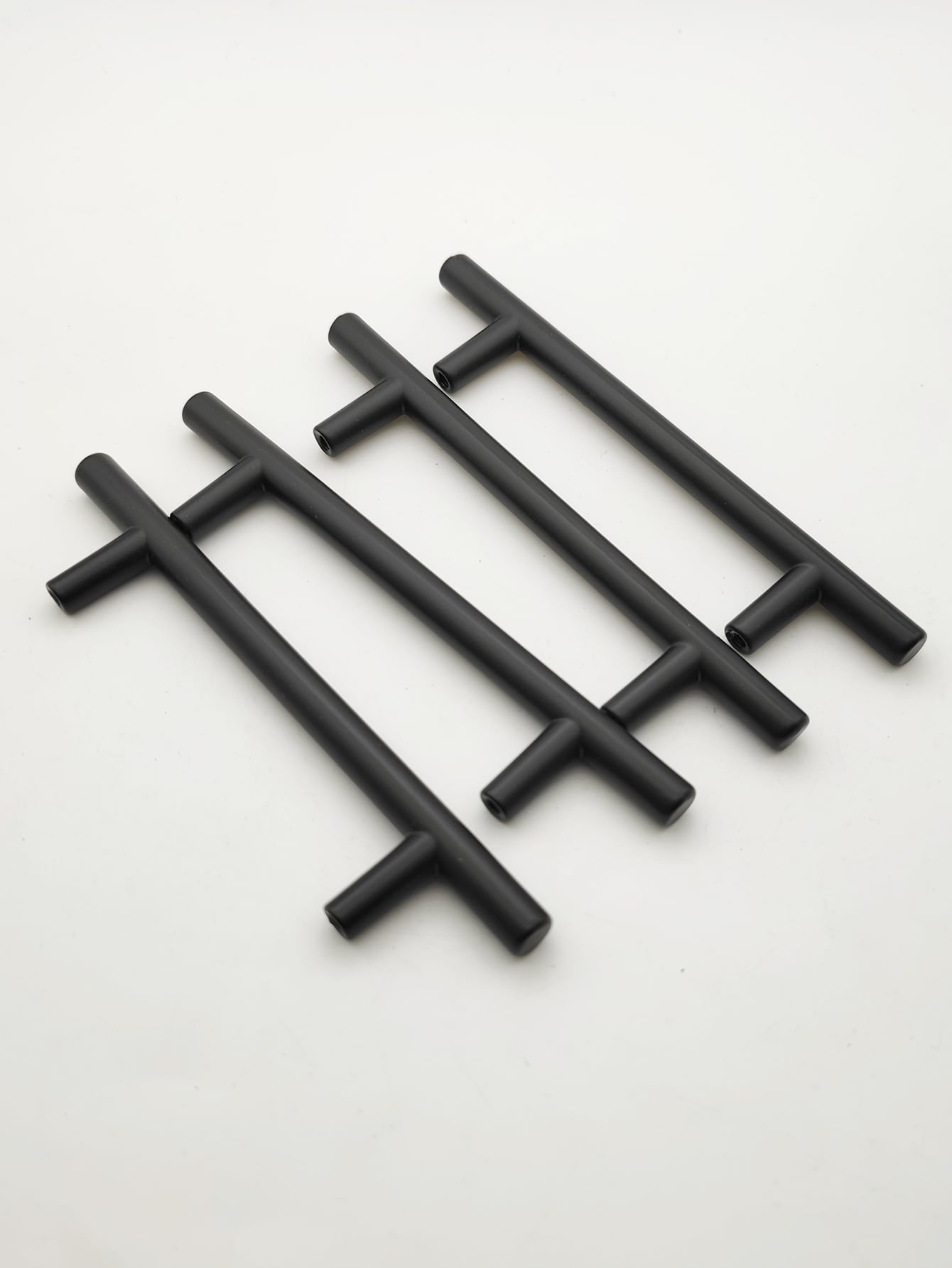 Set of four black cabinet handles made from aluminum alloy, showcasing a modern design suitable for various furniture styles.