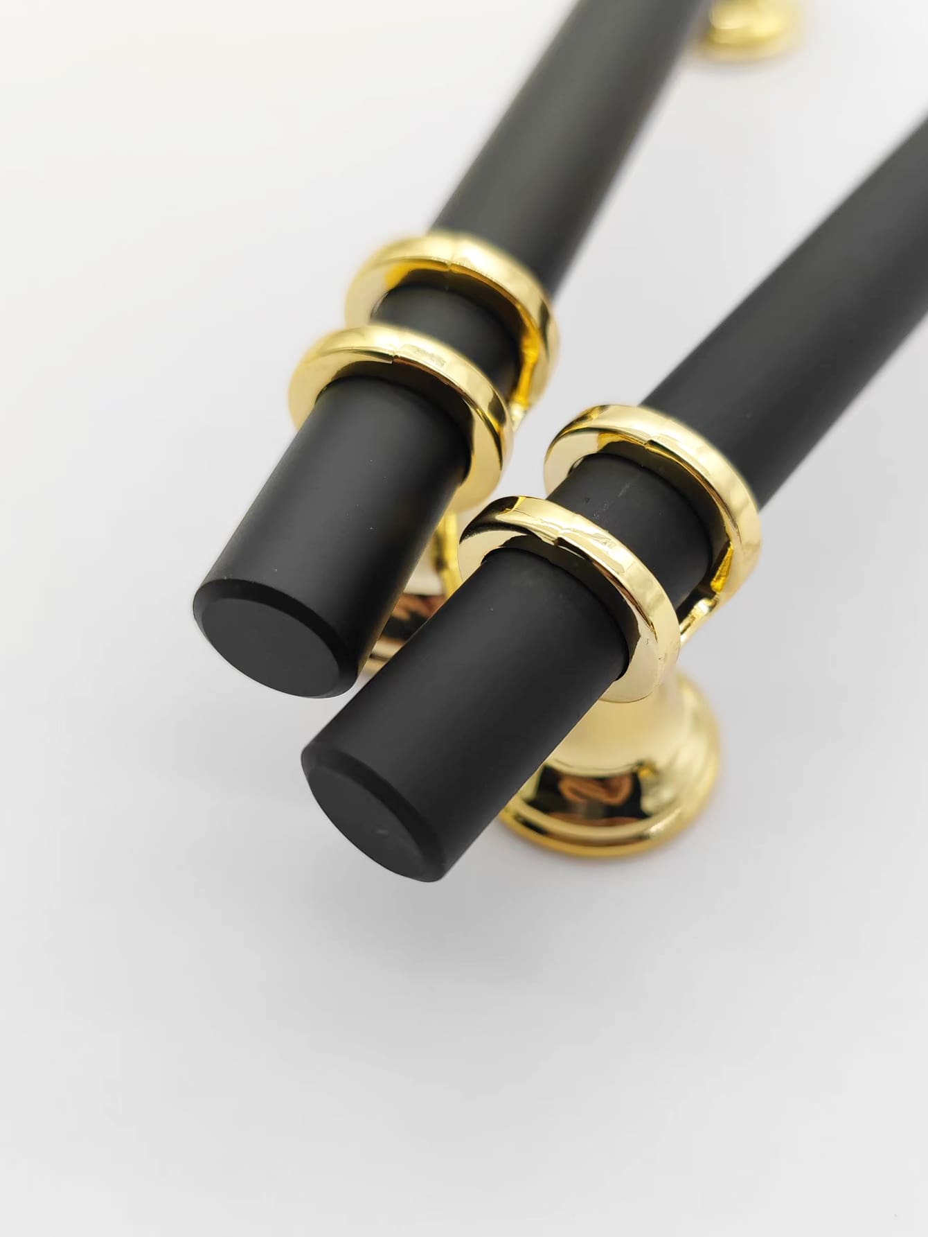 A set of four Lux design RST handles in black and gold, showcasing their elegant and modern style.