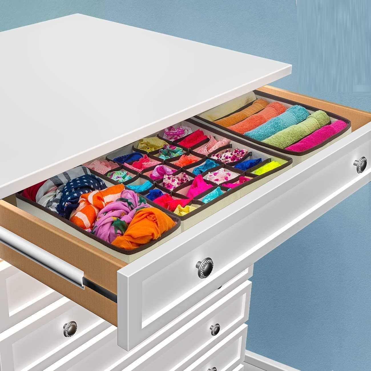 Four black foldable drawer dividers storage boxes arranged neatly, showcasing their multi-sectional design for organizing clothing and personal items.