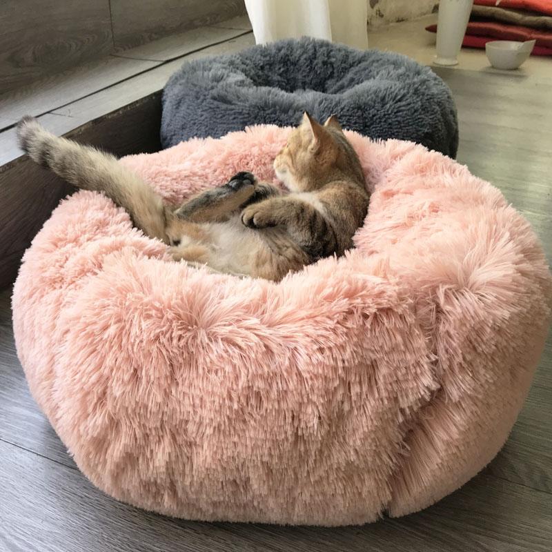 A cozy 40-100cm long plush round dog bed in various colors, designed for ultimate comfort for dogs and cats.