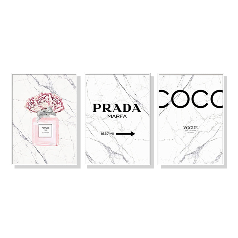 Three elegant canvas prints featuring fashion perfume designs, framed in white, showcasing vibrant colors and a modern floating effect.