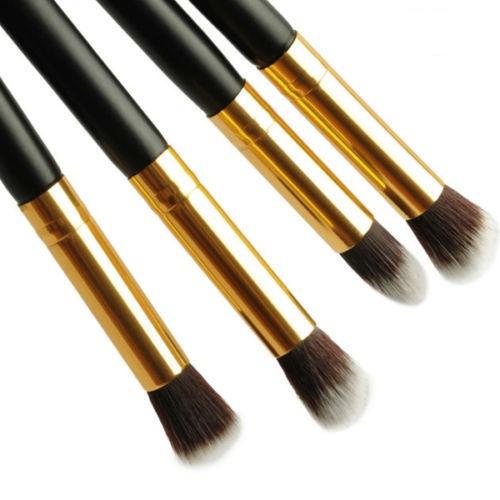 4-piece professional eyeshadow brush set with soft fiber bristles and wooden handles in gold and black color.