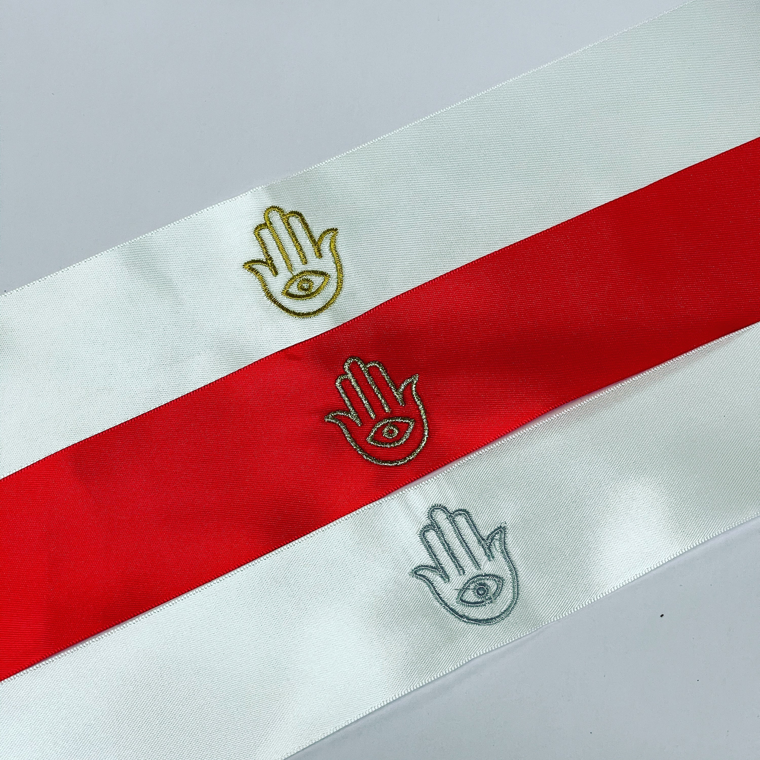 A pack of 50 embroidered Hamsa satin ribbons, each measuring 2 x 20 inches, perfect for henna parties and decorations.