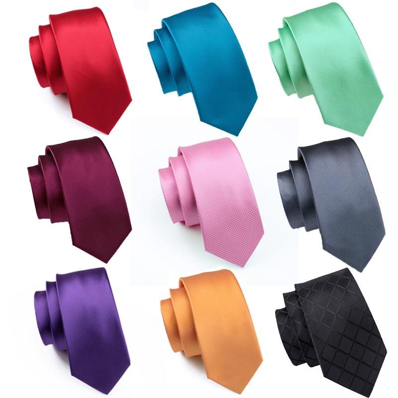 A stylish set of 50 solid color silk men's ties with matching handkerchief and cufflinks, showcasing various colors and elegant design.