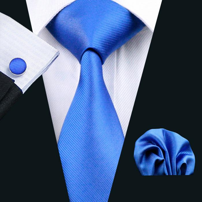 A stylish set of 50 solid color silk men's ties with matching handkerchief and cufflinks, showcasing various colors and elegant design.