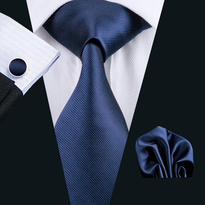 A stylish set of 50 solid color silk men's ties with matching handkerchief and cufflinks, showcasing various colors and elegant design.