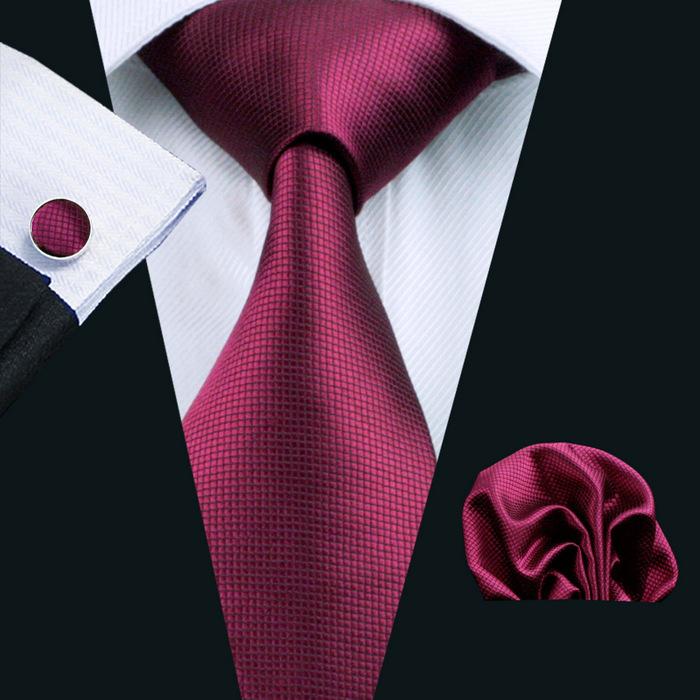 A stylish set of 50 solid color silk men's ties with matching handkerchief and cufflinks, showcasing various colors and elegant design.