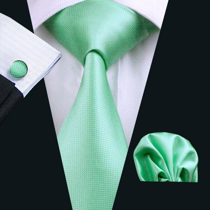 A stylish set of 50 solid color silk men's ties with matching handkerchief and cufflinks, showcasing various colors and elegant design.