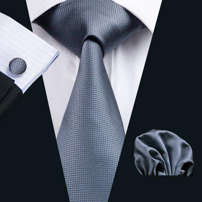 A stylish set of 50 solid color silk men's ties with matching handkerchief and cufflinks, showcasing various colors and elegant design.